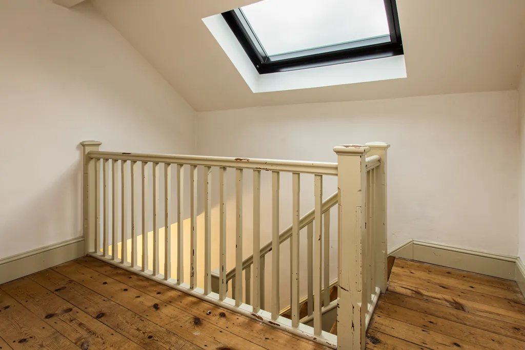 A conservation rooflight over a Georgian landing, with a splayed lime-plastered reveal