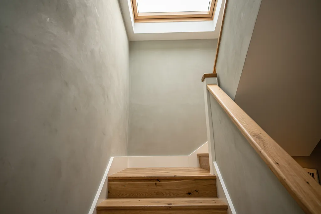 A sun-lit hallway in a new-build home with a rooflight above the stairs