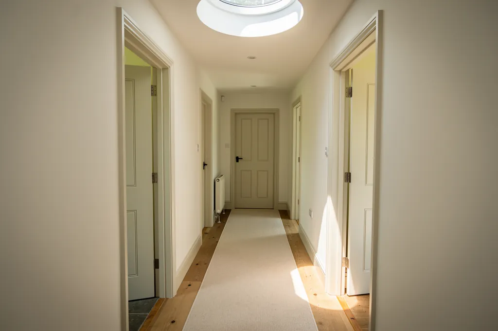 A sun tunnel diffuser lighting a windowless hallway